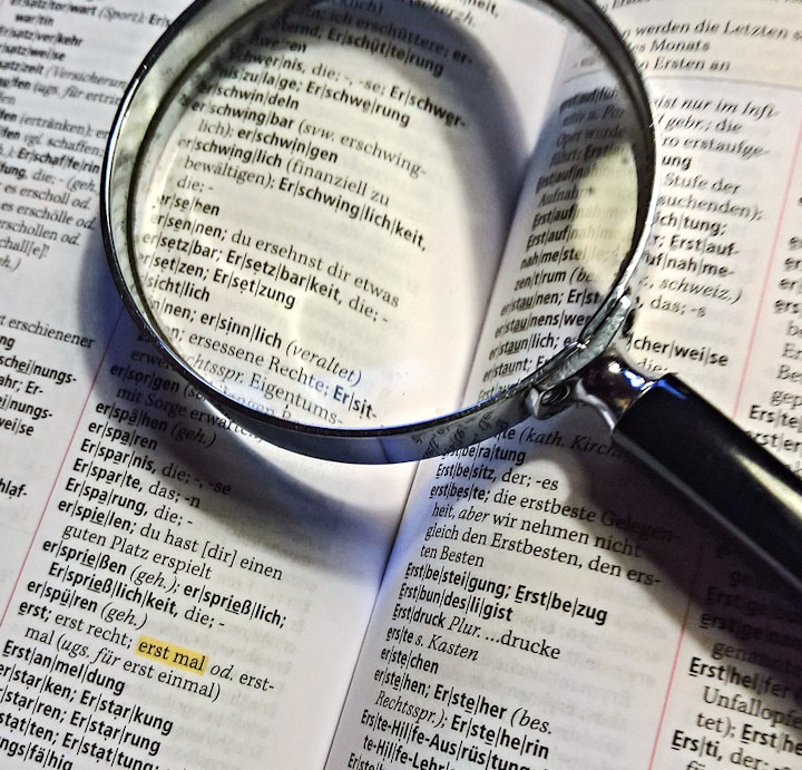 A magnifying glass and an open book