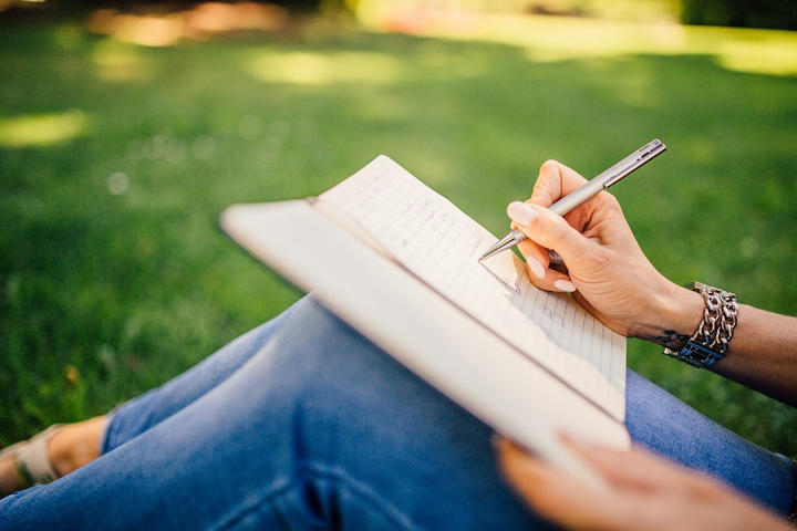 A person writing in a notebook