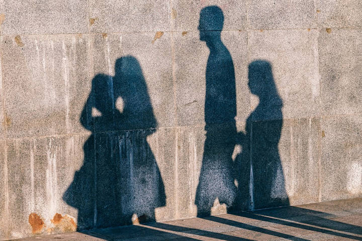 Image of a group of people's shadows cast onto a wall