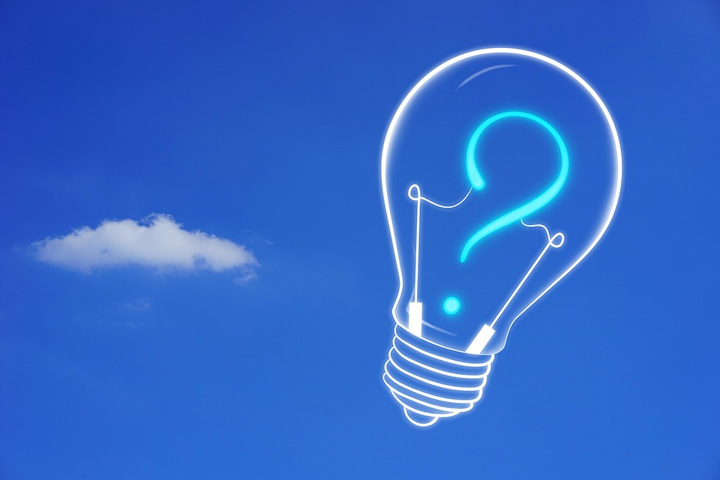 Graphic illustration of a lightbulb with a question mark in it against a blue sky