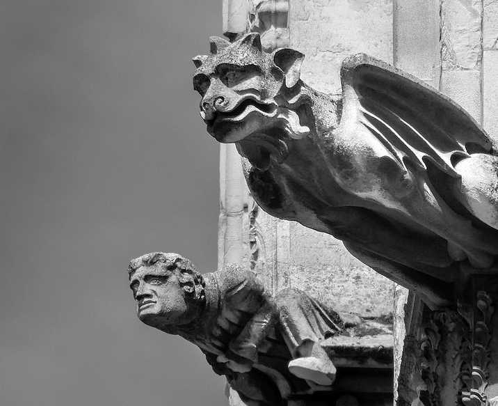 Black and white photograph of two architectural gargoyles