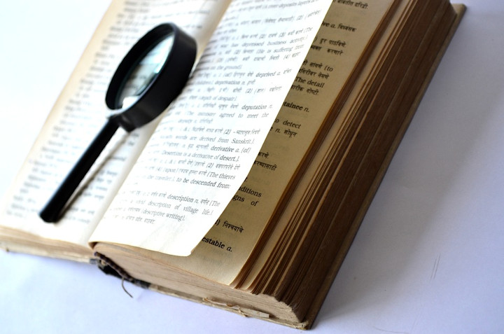 An open book with a magnifying glass