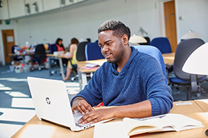 A student working on a laptop.