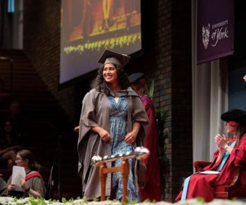 a photo of student maryam graduating on stage