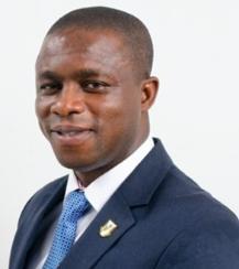 Photograph of Prof Philip Antwi-Agyei smiling and wearing a blue jacket and tie and a white shirt